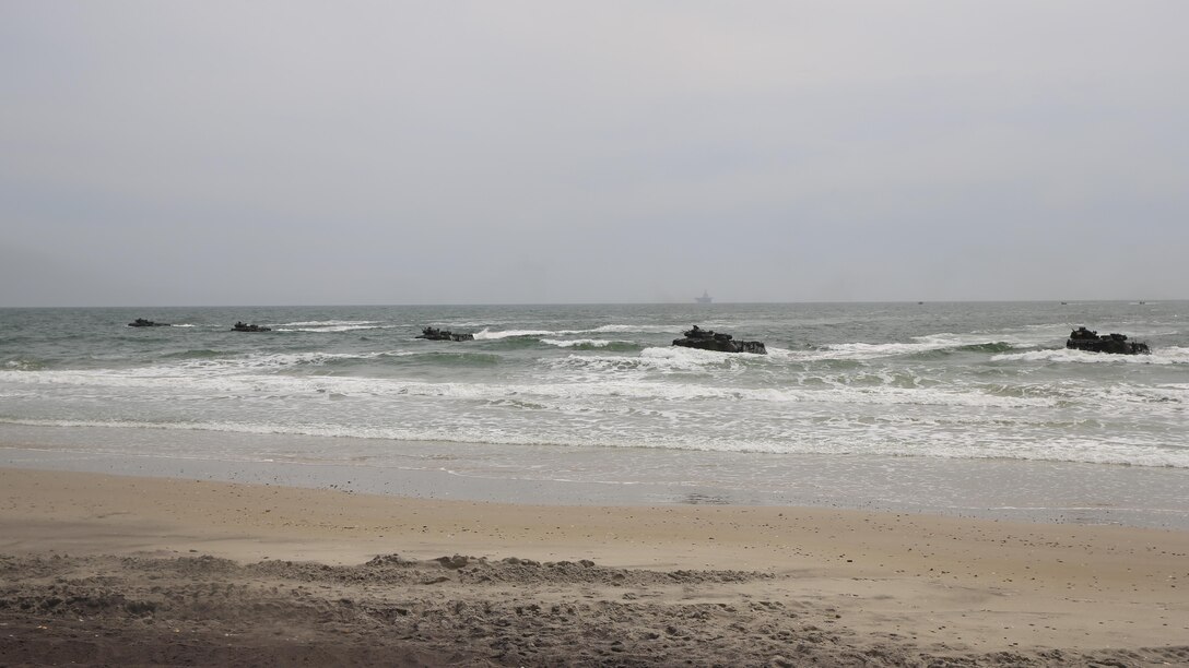 Amphibious Assault Vehicles with 2nd Assault Amphibian Battalion, 2nd Marine Division, approach Onslow Beach, Camp Lejeune, N.C., during an amphibious assault and movement to contact training, April 9, 2015. Each of the vehicles carried Marines with 2nd Battalion, 2nd Marine Regiment and after landing they transported the Marines to a range where the movement to contact portion of the training was to be conducted. 