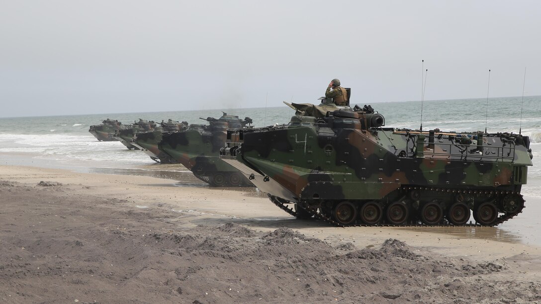Amphibious Assault Vehicles with 2nd Assault Amphibian Battalion, 2nd Marine Division, land on Onslow Beach, Camp Lejeune, N.C. during an amphibious assault and movement to contact training, April 9, 2015. The vehicles departed from the USS Wasp in two waves of five and once all vehicles had landed they prepared to move toward their objective. 