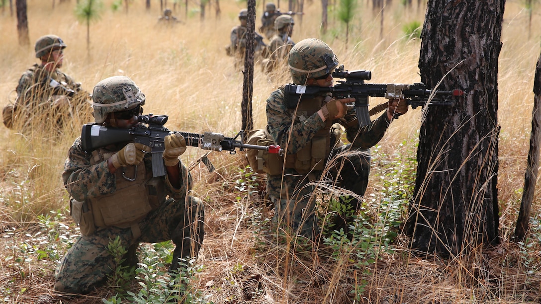 Marines with 2nd Battalion, 2nd Marine Regiment, prepare to begin an assault on a simulated enemy base during movement to contact training aboard Camp Lejeune, N.C., April 9, 2015. Once the assault was completed, the Marines were required to prepare a defense in case of a counterattack. 