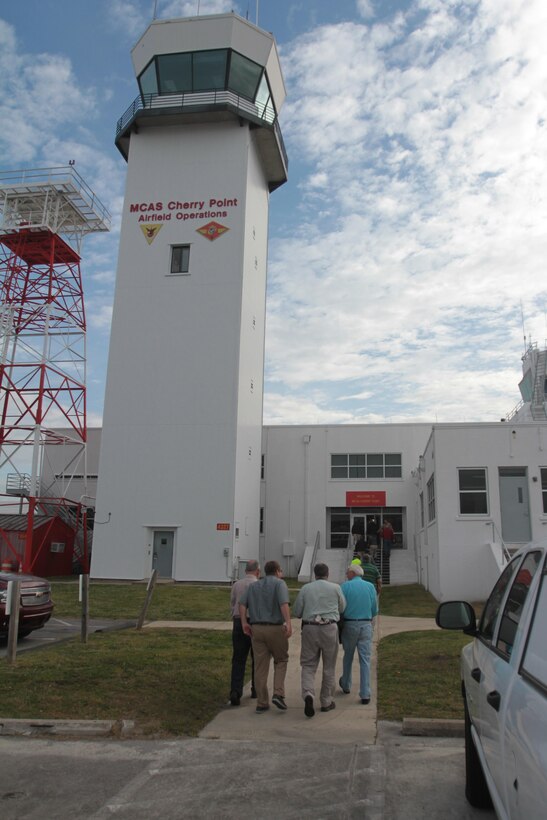 Members of the Civilian Military Community Council and Joint Land Use Study enter the Air Field Operations building at Marine Corps Air Station Cherry Point, N.C., before an aerial tour of the air station's outlying training facilities, April 8, 2015. 
Air station leaders meet periodically with members of the CMCC and JLUS to strengthen ties between Cherry Point and surrounding communities. 
Pilots from Cherry Point and across 2nd Marine Aircraft Wing frequently train at the air station's outlying training facilities to prepare for expeditionary operations, sea-based force projection and aviation support of the Marine Air-Ground Task Force.