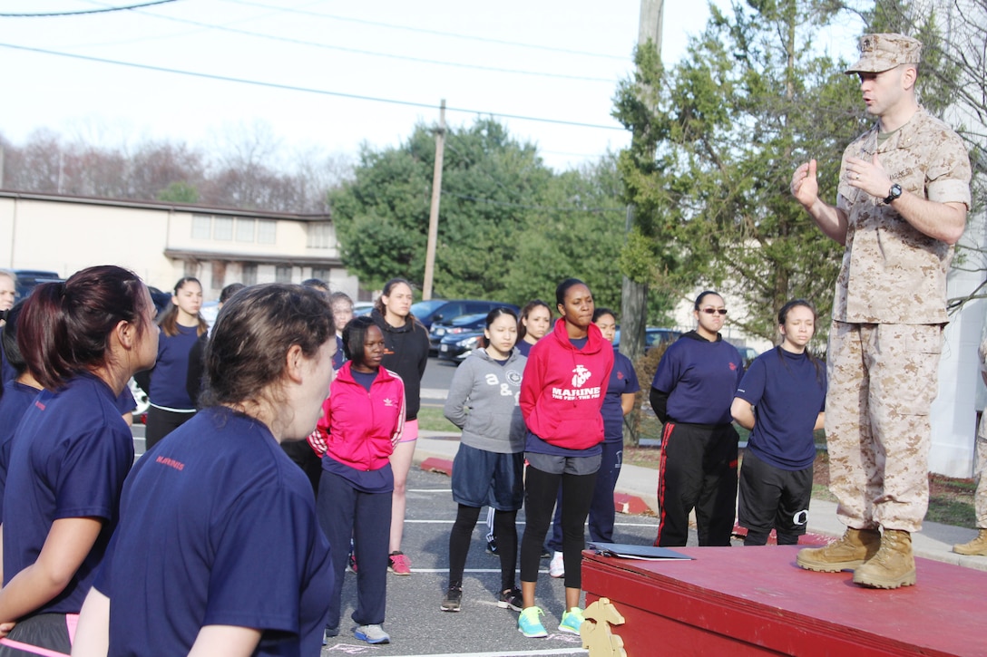 Maj. John F. Campbell, commanding officer of Marine Corps Recruiting Station New Jersey, explains the importance of the 2015 Annual Female Pool Function to more than fifty poolees at Naval Weapons Station Earle in Colts Neck, N.J., April 11, 2015. 