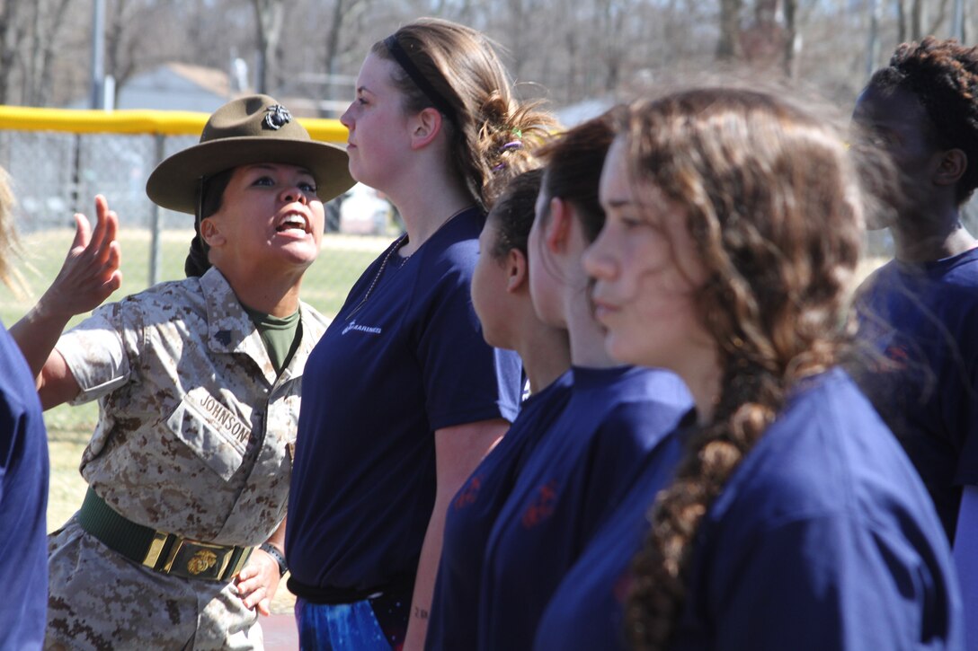 Sgt. Stephanie Johnson, drill instructor stationed at Marine Corps Recruit Depot Parris Island, S.C., corrects a female poolee during the "drill instructor time" drill at the 2015 Annual Female Pool Function at Naval Weapons Station Earle in Colts Neck, N.J., April 11, 2015. 