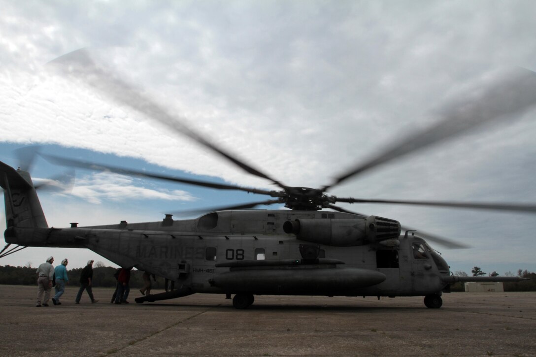 Members of the Civilian Military Community Council and Joint Land Use Study board a CH-53E Super Stallion at Outlying Field Atlantic during an aerial tour of Marine Corps Air Station Cherry Point's outlying training facilities, April 8, 2015. 
Air station leaders meet periodically with members of the CMCC and JLUS to strengthen ties between Cherry Point and surrounding communities. 
Pilots from Cherry Point and across 2nd Marine Aircraft Wing frequently train at OLF Atlantic to prepare for expeditionary operations, sea-based force projection and aviation support of the Marine Air-Ground Task Force.