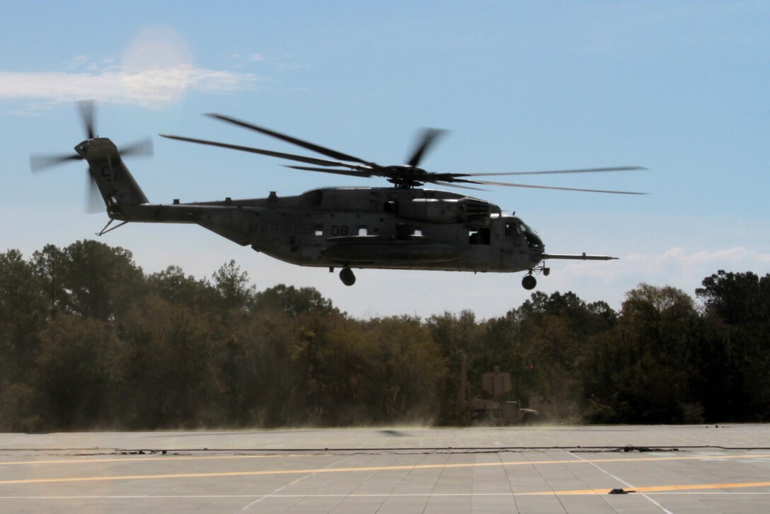 A CH-53E Super Stallion belonging to Marine Heavy Helicopter Squadron 461 departs Auxiliary Landing Field Bogue, April 8, 2015.
The aircraft was part of an aerial tour of Marine Corps Air Station Cherry Point's outlying training facilities for members of the Civilian Military Community Council and Joint Land Use Study hosted by the air station. Air station leaders meet periodically with members of the CMCC and JLUS to strengthen ties between Cherry Point and surrounding communities. 
Pilots from Cherry Point and across 2nd Marine Aircraft Wing frequently train at ALF Bogue to prepare for expeditionary operations, sea-based force projection and aviation support of the Marine Air-Ground Task Force.