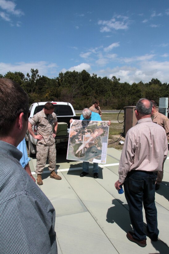 Carteret County Commissioner Bill Smith holds a map depicting an aerial view of Auxiliary Landing Field Bogue during an aerial tour of Marine Corps Air Station Cherry Point's outlying training facilities, April 8, 2015. 
Air station leaders meet periodically with members of the Civilian Military Community Council and Joint Land Use Study to strengthen ties between Cherry Point and surrounding communities. 
Pilots from Cherry Point and across 2nd Marine Aircraft Wing frequently train at ALF Bogue to prepare for expeditionary operations, sea-based force projection and aviation support of the Marine Air-Ground Task Force.