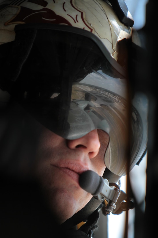 Staff Sgt. Troy Little takes-in a view of Marine Corps Air Station Cherry Point, N.C., from inside a CH-53E Super Stallion belonging to Marine Heavy Helicopter Squadron 461, April 8, 2015. 
Little and several other Marines from HMH-461 provided a lift for members of the Civilian Military Community Council and Joint Land Use Study during an aerial tour of Cherry Point's outlying training facilities hosted by the air station. 
Pilots from Cherry Point and across 2nd Marine Aircraft Wing frequently train at the air station's outlying training facilities to prepare for expeditionary operations, sea-based force projection and aviation support of the Marine Air-Ground Task Force. 
Little is a crew chief with HMH-461 and native of Kissimmee, Fla.