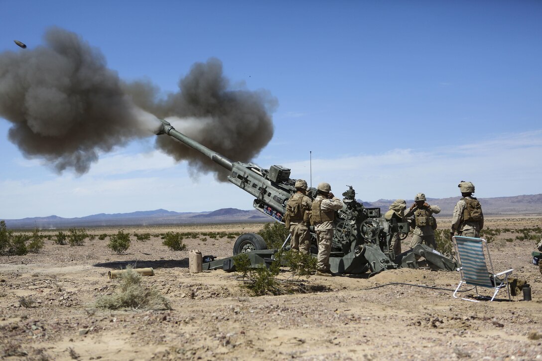 Marines with 1st Battalion, 11th Marine Regiment, 1st Marine Division, fire an M777 howitzer during Exercise Desert Scimitar 2015 aboard Marine Corps Air Ground Combat Center Twentynine Palms, Calif., April 7, 2015. The tough, realistic live-fire training central to Desert Scimitar allows Division units to train in order to maintain readiness and meet current and real-world operational demands.