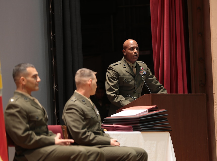 Col. Michael D. Robinson, director, Tactical Training Exercise Control Group, addresses Basic Communications Officer Course 1-15 students during the class’ graduation ceremony at the Combat Center Auditorium, April 7, 2015. (Official Marine Corps photo by Lance Cpl. Medina Ayala-Lo/Released)