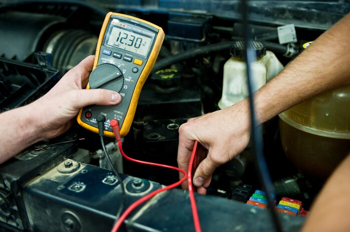Airman 1st Class Chris Hoover and Staff Sgt. Kevin Kotrola, 99th Logistics Readiness Squadron Vehicle Management Flight vehicle maintenance mechanics, troubleshoot a van’s anti-lock braking system at Nellis Air Force Base, Nev., April 7, 2015. The vehicle management flight team manages the largest fleet in Air Combat Command with over 1,500 vehicles. (U.S. Air Force photo by Airman 1st Class Jake E. Carter)