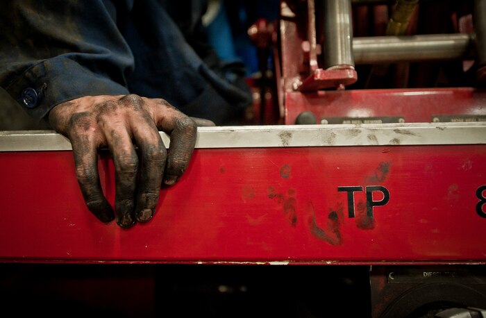 Airman 1st Class John Bordenkircher, 99th Logistics Readiness Squadron Vehicle Management Flight fire truck maintainer, rests his hand on a fire truck at Nellis Air Force Base, Nev., April 7, 2015. The fire truck maintenance section is responsible for providing all of the maintenance on approximately 20 fire trucks used on Nellis and Creech AFBs, and the Nevada Test and Training Range. (U.S. Air Force photo by Staff Sgt. Siuta B. Ika)