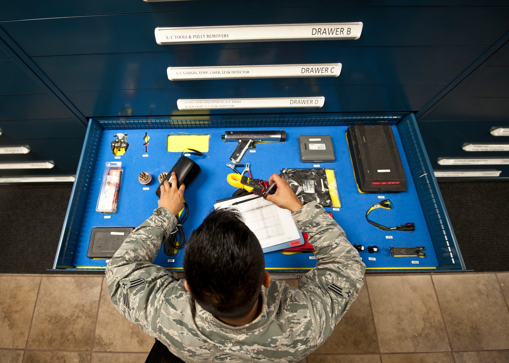 Senior Airman Rey Tolentino, 99th Logistics Readiness Squadron Vehicle Management Flight material control expeditor, conducts an inventory on a consolidated tool box at Nellis Air Force Base, Nev., April 7, 2015. Tolentino and other material control Airmen must conduct inventories on all consolidated tool boxes every six months to ensure the tools are still serviceable. (U.S. Air Force photo by Staff Sgt. Siuta B. Ika) 
