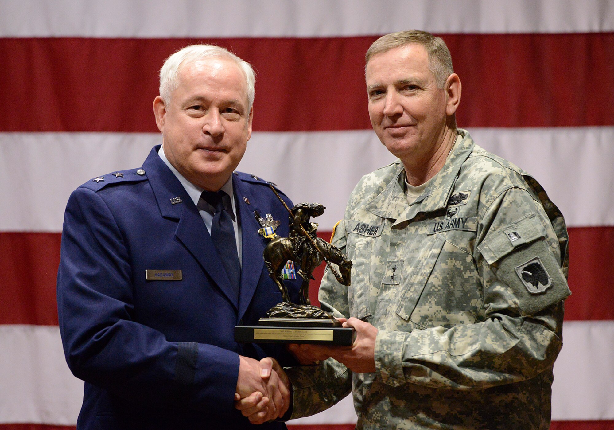 Maj. Gen William S. Hadaway III, former Director of Logistics, National Guard Bureau, receives a token of appreciation for his many years of service from Oklahoma Adjutant General, Maj. Gen. Robbie Asher, April 11, at the Brig. Gen. Joseph W. Turner complex, Tulsa Air National Guard Base, Okla.  Hadaway was a former wing commander at the 138th Fighter Wing in Tulsa from Jan. 2004 to May 2008.  (U.S. National Guard photo by Master Sgt. Mark A. Moore/Released)