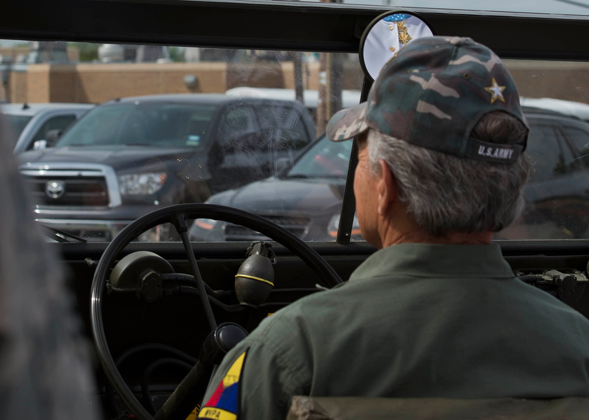 Michael Fitzmaurice’s Medal of Honor reflects in the rear-view mirror during the Gainesville, Texas, Medal of Honor Parade, April 11, 2015.  More than 40 Airmen, Soldiers and Sailors from Sheppard Air Force Base, Texas, volunteered to escort the Medal of Honor recipients during the parade. (U.S. Air Force photo by Senior Airman Kyle Gese/Released))

