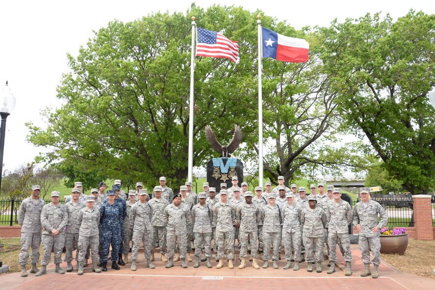 Airmen, Soldiers and Sailors stand in front of the Medal of Honor memorial in Gainesville, Texas, April 11, 2015. The group escorted 16 Medal of Honor recipients in the Gainesville Medal of Honor parade earlier that day. Gainesville was said to be the most patriotic city in America in 2012, according to a KXII news article. Gainesville is also the Medal of Honor host city that was established in 2001. (U.S. Air Force photo by Airman 1st Class Robert L. McIlrath)