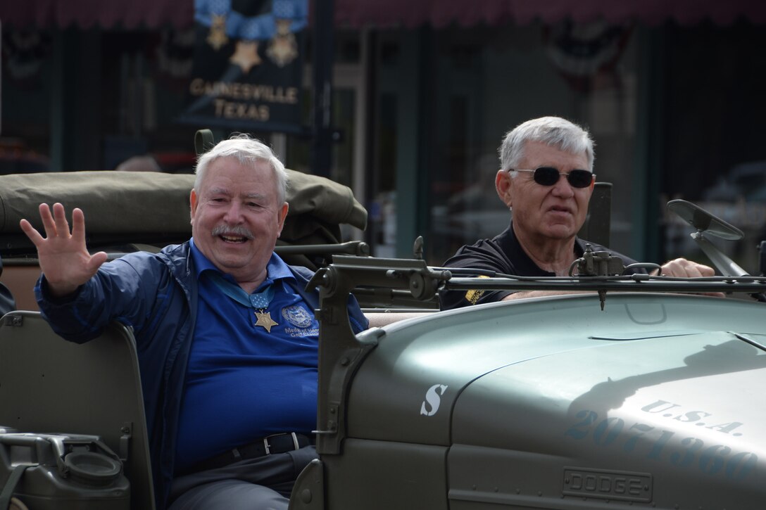 Don Ballard waves during the Medal of Honor parade in Gainesville, Texas, April 11, 2015. Ballard along with 15 other Medal of Honor recipients participated in the parade. Afterwards, those who attended the parade were invited to a book-signing event. (U.S. Air Force photo by Airman 1st Class Robert L. McIlrath)