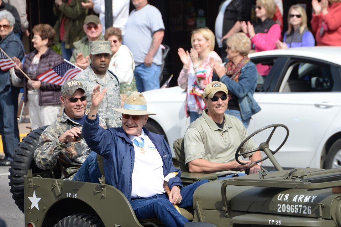 Duane E. Dewey waves to a cheering crowd during Medal of Honor parade in Gainesville, Texas, April 11, 2015. Dewey along with 15 other Medal of Honor recipients participated in the parade. Afterwards, those who attended the parade were invited to a book-signing event. (U.S. Air Force photo by Airman 1st Class Robert L. McIlrath)