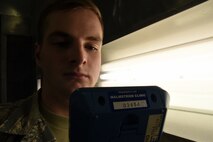 Airman 1st Class William Raetz, 341st Medical Operations Squadron bioenvironmental engineering technician, performs a ventilation survey inside a paint booth at the Auto Hobby shop April 8, 2015, Malmstrom Air Force Base, Mont. Bioenvironmental routinely monitor 66 ventilation systems across the base to ensure safe working conditions. (U.S. Air Force photo/Chris Willis)