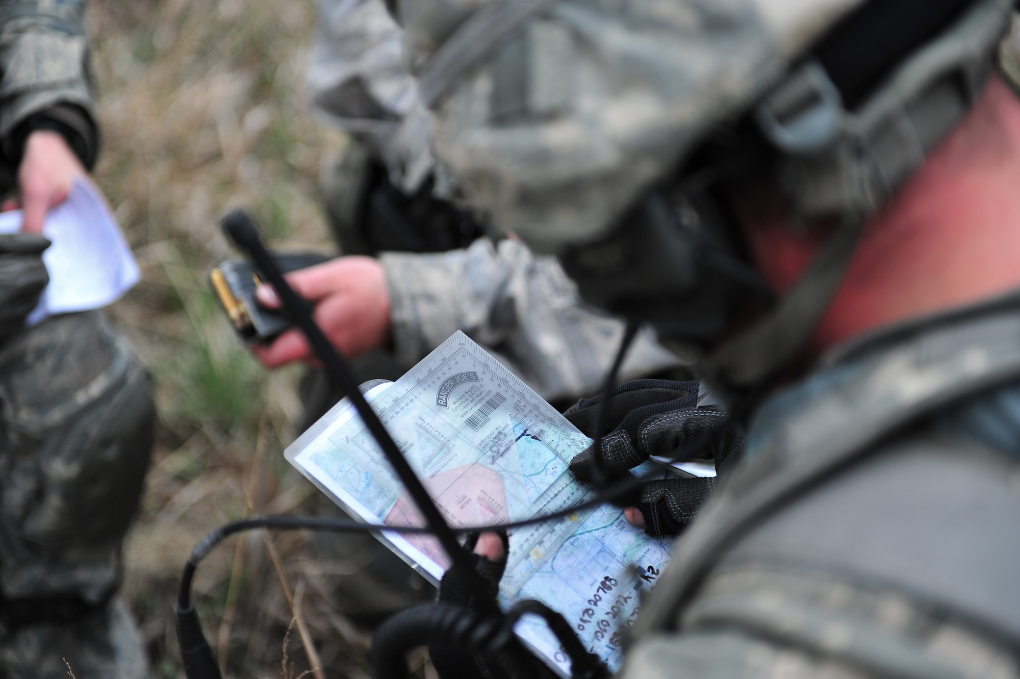 Air Force Reserve security forces members covertly review and plan their next position move on a map during a training  mission April 9, 2015, at the U.S. Air Force Academy in Colorado Springs, Colo. The 710th and 310th Security Forces Squadrons held a joint combat leaders course while living in field conditions. The 710th SFS is out of Buckley Air Force Base, Colo., and the 310th is out of Schriever AFB.
(U.S. Air Force photo/Tech. Sgt. Nicholas B. Ontiveros)