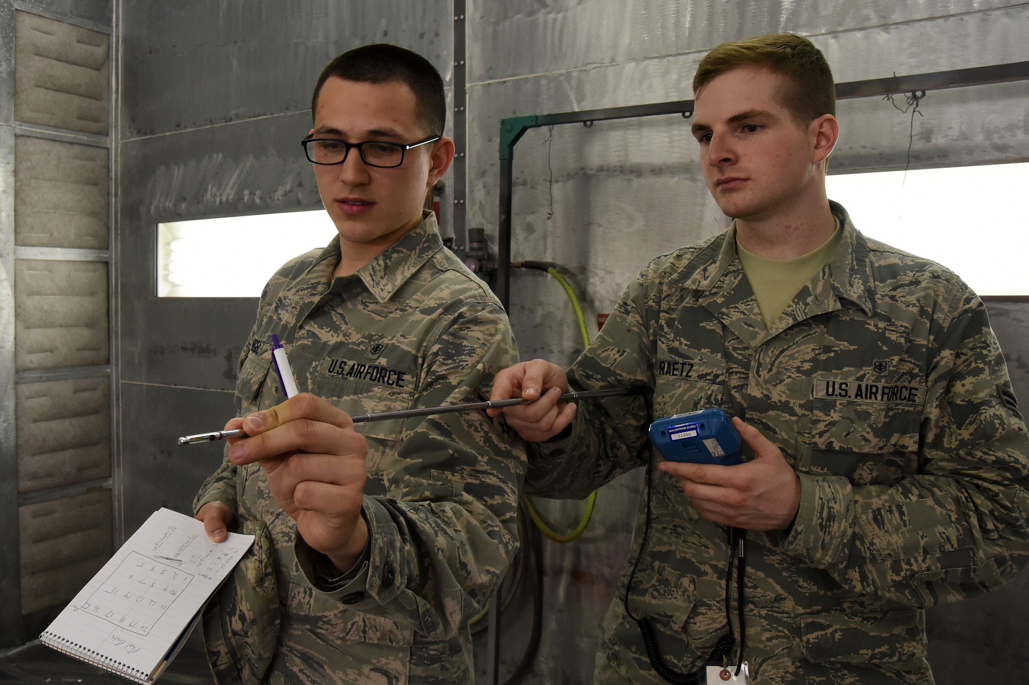 Airman 1st Class Joel Rogel, left, and William Raetz, 341st Medical Operations Squadron bioenvironmental engineering technicians, perform a ventilation survey inside a paint booth at the Auto Hobby shop April 8, 2015, Malmstrom Air Force Base, Mont. Bioenvironmental routinely monitor 66 ventilation systems across the base to ensure safe working conditions. (U.S. Air Force photo/Chris Willis)