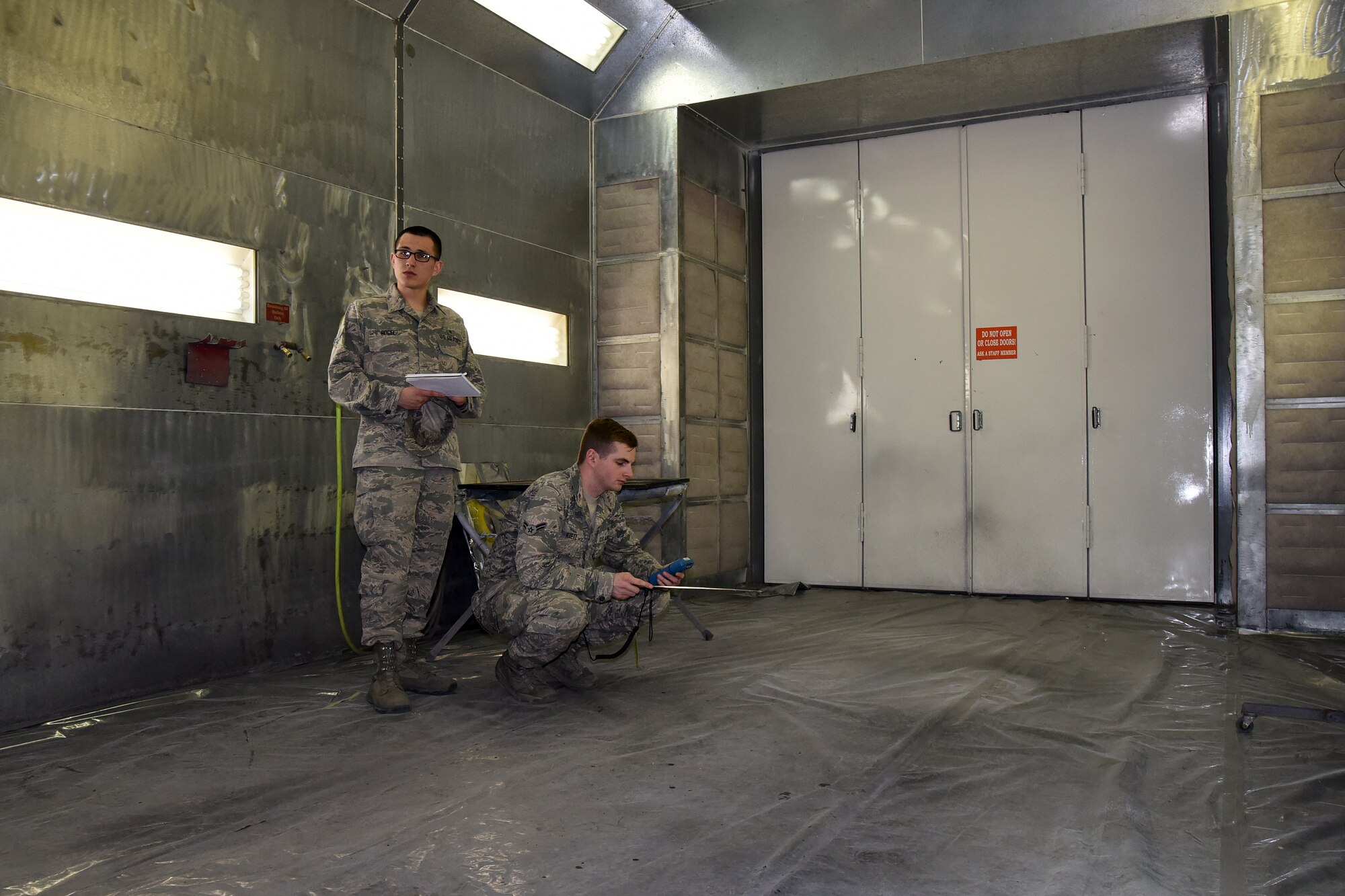 Airman 1st Class Joel Rogel, left, and William Raetz, 341st Medical Operations Squadron bioenvironmental engineering technicians, perform a ventilation survey inside a paint booth at the Auto Hobby shop April 8, 2015, Malmstrom Air Force Base, Mont. Bioenvironmental routinely monitor 66 ventilation systems across the base to ensure safe working conditions. (U.S. Air Force photo/Chris Willis)