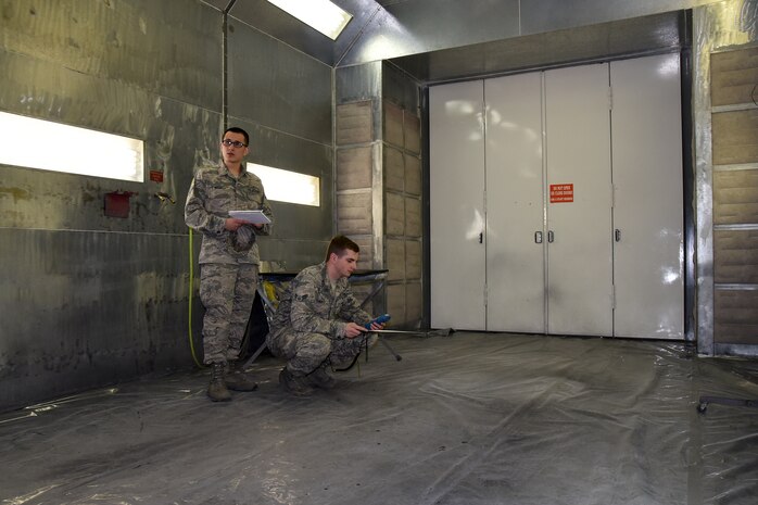 Airman 1st Class Joel Rogel, left, and William Raetz, 341st Medical Operations Squadron bioenvironmental engineering technicians, perform a ventilation survey inside a paint booth at the Auto Hobby shop April 8, 2015, Malmstrom Air Force Base, Mont. Bioenvironmental routinely monitor 66 ventilation systems across the base to ensure safe working conditions. (U.S. Air Force photo/Chris Willis)