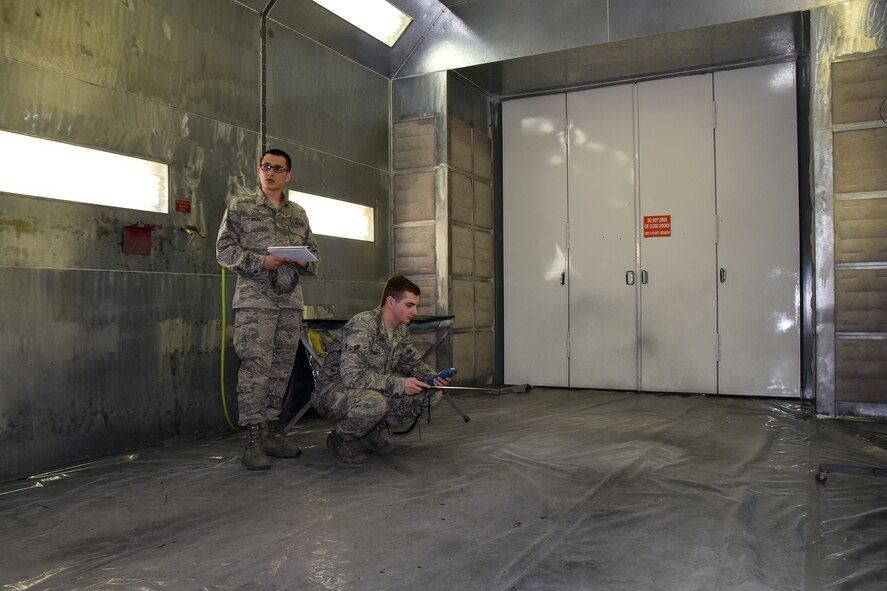 Airman 1st Class Joel Rogel, left, and William Raetz, 341st Medical Operations Squadron bioenvironmental engineering technicians, perform a ventilation survey inside a paint booth at the Auto Hobby shop April 8, 2015, Malmstrom Air Force Base, Mont. Bioenvironmental routinely monitor 66 ventilation systems across the base to ensure safe working conditions. (U.S. Air Force photo/Chris Willis)