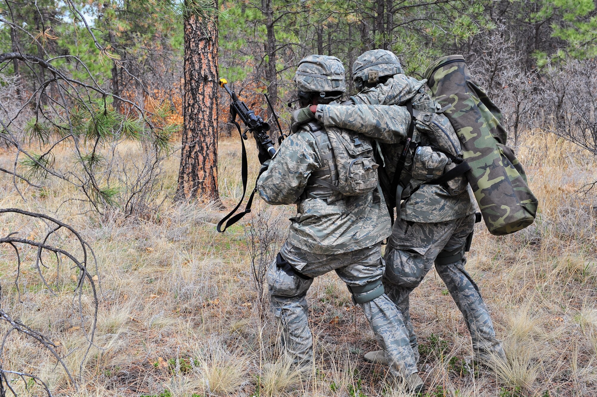 An Air Force Reservist helps carry off a simulated wounded to a neutral area during an ambush training  mission April 9, 2015, at the U.S. Air Force Academy in Colorado Springs, Colo. The 710th and 310th Security Forces Squadrons held a joint combat leaders course while living in field conditions. The 710th SFS is out of Buckley Air Force Base, Colo., and the 310th is out of Schriever AFB.
(U.S. Air Force photo/Tech. Sgt. Nicholas B. Ontiveros)