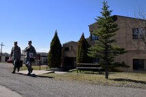 Airman 1st Class Joel Rogel, left, and William Raetz, 341st Medical Operations Squadron bioenvironmental engineering technicians, leave their building to perform a ventilation survey at the Auto Hobby shop April 8, 2015 at Malmstrom Air Force Base, Mont. Bioenvironmental routinely monitor 66 ventilation systems across the base to ensure safe working conditions. (U.S. Air Force photo/Chris Willis)