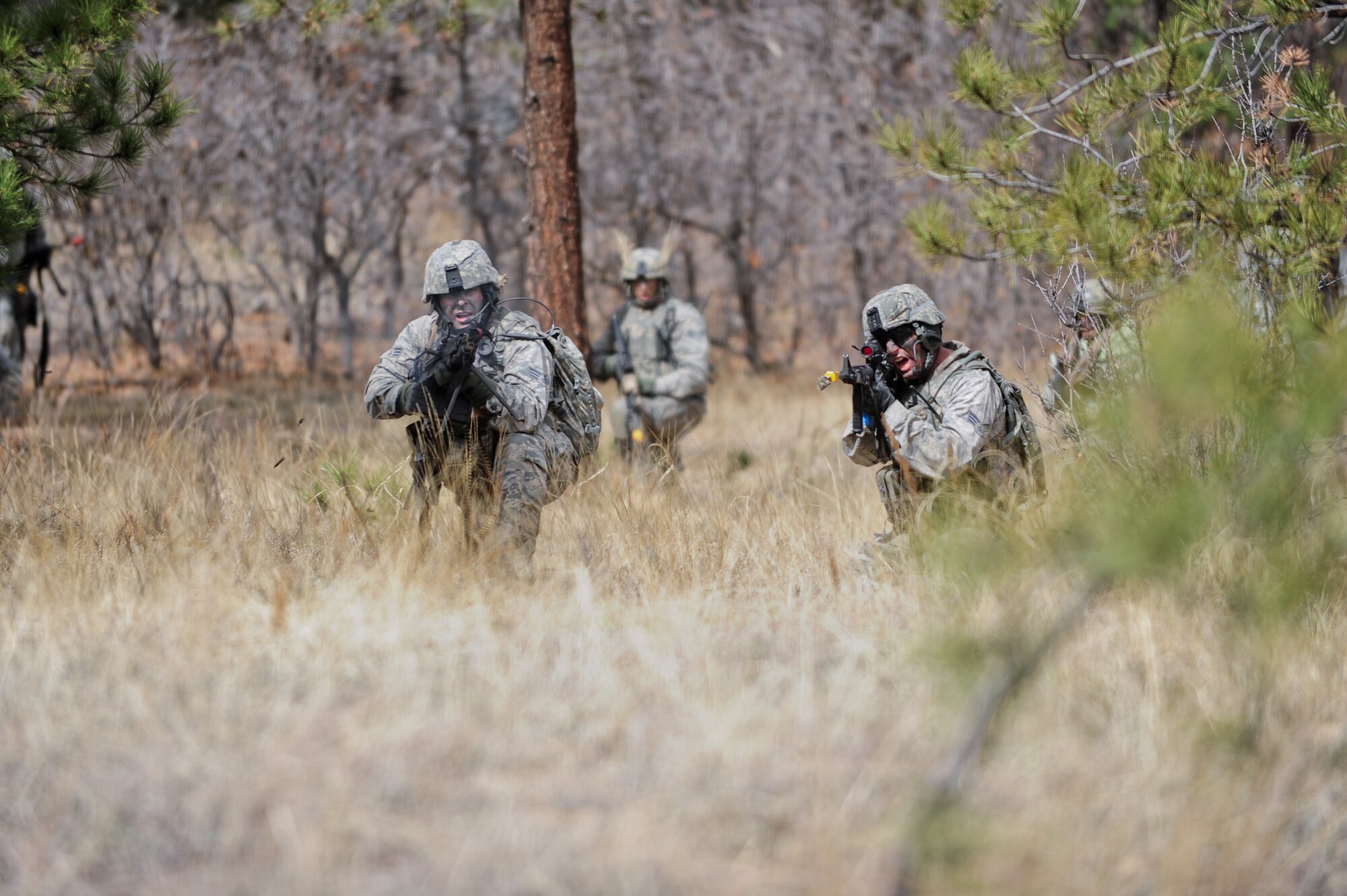 Air Force Reservists Senior Airman William Skinner and Senior Airman James Protsman quickly return fire at an enemy’s ambush during a training  mission April 9, 2015, at the U.S. Air Force Academy in Colorado Springs, Colo. The 710th and 310th Security Forces Squadrons held a joint combat leaders course while living in field conditions. The 710th SFS is out of Buckley Air Force Base, Colo., and the 310th is out of Schriever AFB.
(U.S. Air Force photo/Tech. Sgt. Nicholas B. Ontiveros)
