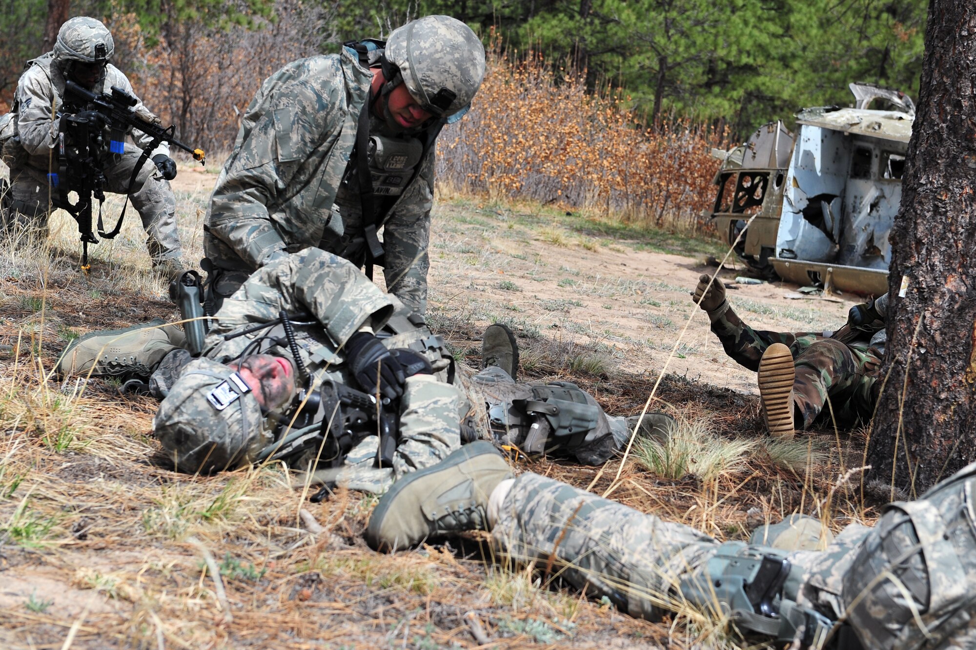 Air Force Reserve Tech. Sgt. Christopher Lavin provides combat medical attention during a simulated ambush April 9, 2015, at the U.S. Air Force Academy in Colorado Springs, Colo. The 710th and 310th Security Forces Squadrons held a joint combat leaders course while living in field conditions. The 710th SFS is out of Buckley Air Force Base, Colo., and the 310th is out of Schriever AFB.  
(U.S. Air Force photo/Tech. Sgt. Nicholas B. Ontiveros)