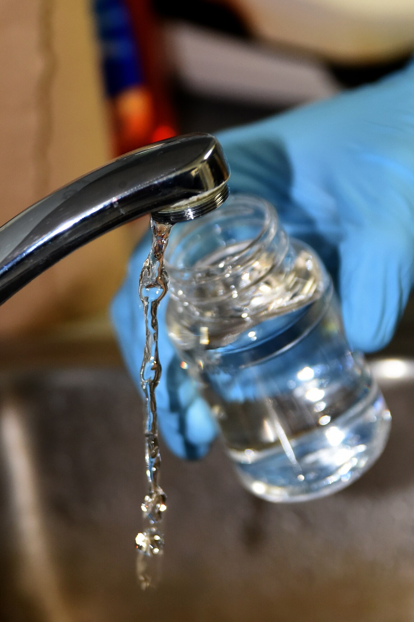 Airman 1st Class William Raetz, 341st Medical Operations Squadron bioenvironmental engineering technician, collects state compliance drinking water samples April 8, 2015 at Malmstrom Air Force Base, Mont. Bioenvironmental collects 10 bacteriological samples every month to ensure safe drinking water. (U.S. Air Force photo/Chris Willis)