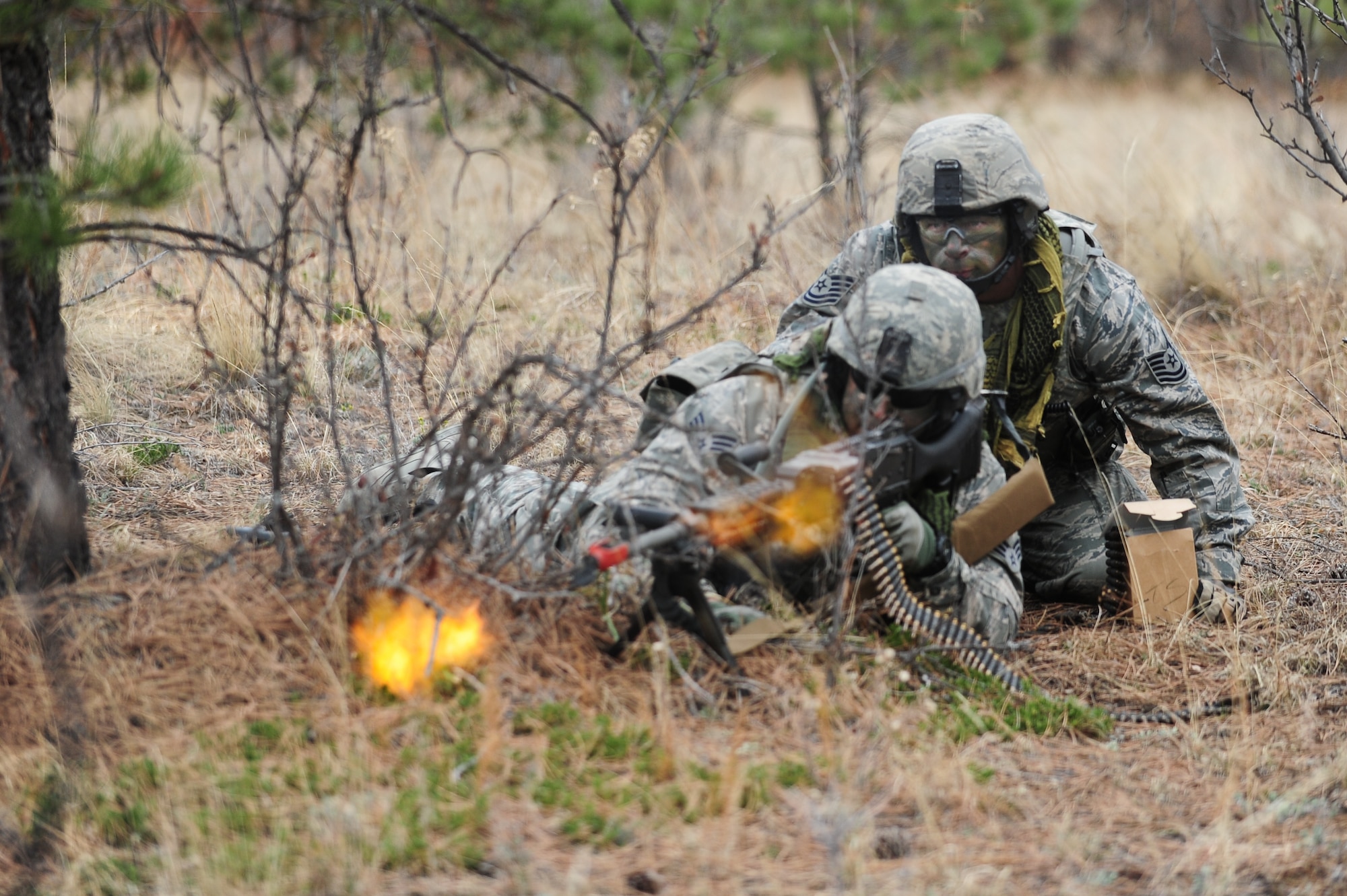 Air Force Reservists Senior Airman Justin Gaitan and Tech. Sgt Nicholas Bricker aggressively fire at fast approaching enemies during a training  mission April 9, 2015, at the U.S. Air Force Academy in Colorado Springs, Colo. The 710th and 310th Security Forces Squadrons held a joint combat leaders course while living in field conditions. The 710th SFS is out of Buckley Air Force Base, Colo., and the 310th is out of Schriever AFB.
(U.S. Air Force photo/Tech. Sgt. Nicholas B. Ontiveros)
