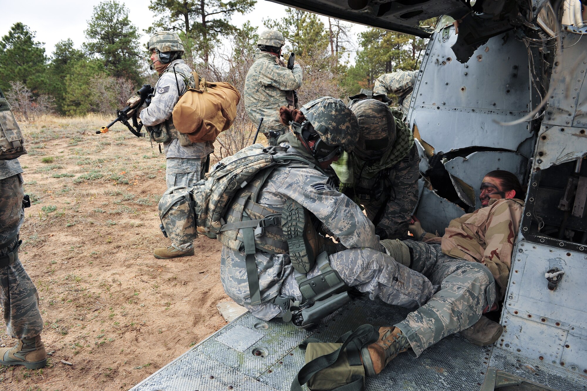 Air Force Reserve Capt. April Harker receives simulated combat medical attention from Senior Airman Oceana Goodsell during a simulated personnel recovery mission April 9, 2015, at the U.S. Air Force Academy in Colorado Springs, Colo. The 710th and 310th Security Forces Squadrons held a joint combat leaders course while living in field conditions. The 710th SFS is out of Buckley Air Force Base, Colo., and the 310th is out of Schriever AFB.
(U.S. Air Force photo/Tech. Sgt. Nicholas B. Ontiveros)