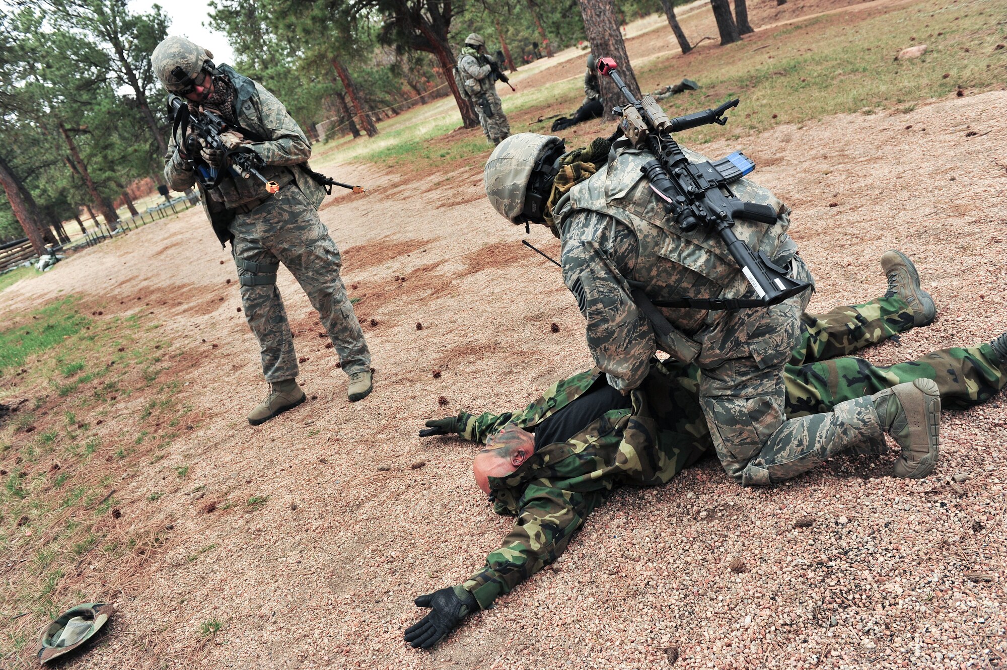 Air Force Reservists Tech. Sgt. Christopher Lavin provides protection as Tech. Sgt. Nicholas Bricker searches a simulated enemy for weapons and items of importance during an ambush April 9, 2015, at the U.S. Air Force Academy in Colorado Springs, Colo. The 710th and 310th Security Forces Squadrons held a joint combat leaders course while living in field conditions. The 710th SFS is out of Buckley Air Force Base, Colo., and the 310th is out of Schriever AFB.
(U.S. Air Force photo/Tech. Sgt. Nicholas B. Ontiveros)