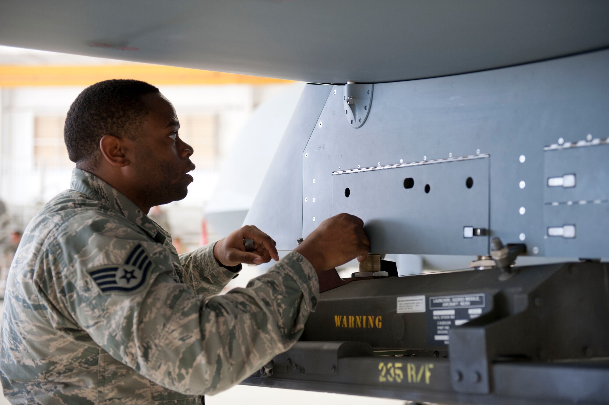 Staff Sgt. Samuel Williams, 49th Aircraft Maintenance Squadron, a member of weapon load crew 50, completes a final walk around inspections of the MQ-9 Reaper during a weapons load competition at Holloman Air Force Base, N.M. April 10, 2015. The MQ-9 load crew participated in the competition to have their skills evaluated. For the competition, points are awarded for weapons-loading, toolkit inspection, and uniform inspection. (U.S. Air Force photo by Staff Sgt. E’Lysia A. Wray/Released)