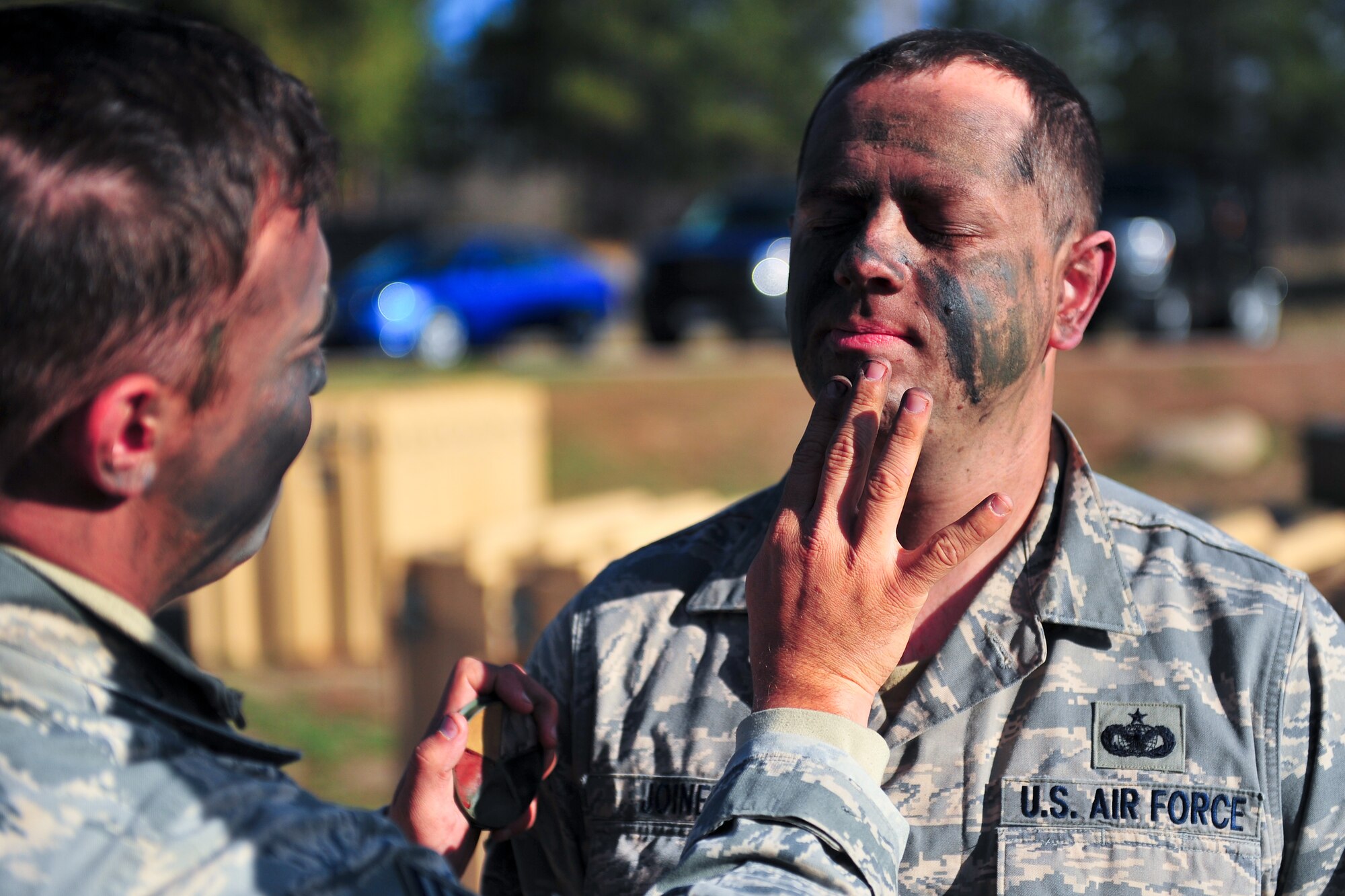 Air Force Reserve Tech. Sgt. Scott Joiner gets help with his face camouflage April 9, 2015, at the U.S. Air Force Academy in Colorado Springs, Colo. The 710th and 310th Security Forces Squadrons held a joint combat leaders course while living in field conditions. The 710th SFS is out of Buckley Air Force Base, Colo., and the 310th is out of Schriever AFB.
(U.S. Air Force photo/Tech. Sgt. Nicholas B. Ontiveros)