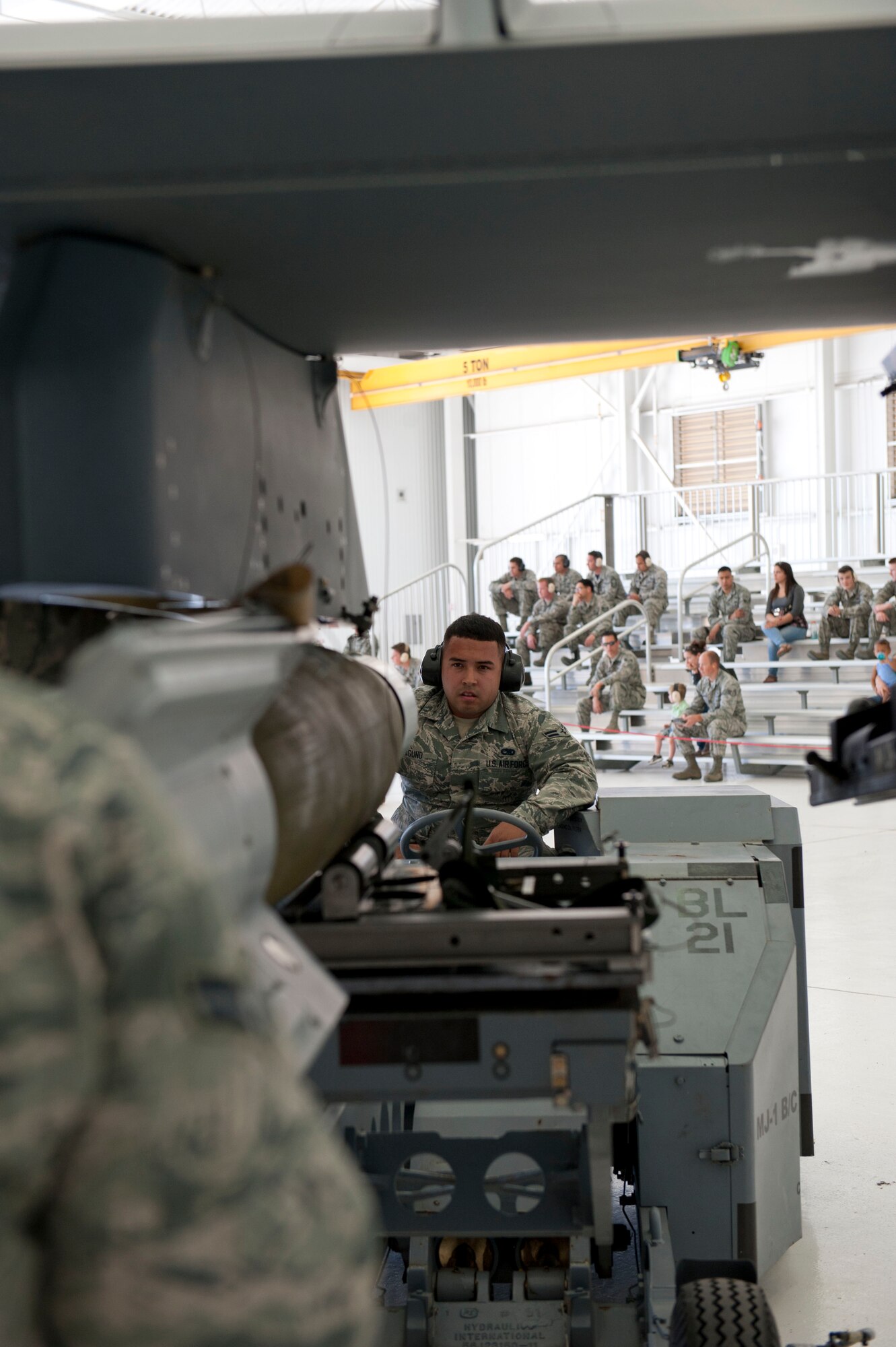 Airman 1st Class Eric Llaguno, 49th Aircraft Maintenance Squadron, a member of weapon load crew 50, uses a MJ-1B Bomblift to assist with loading an AGM-114 Hellfire during a weapons load competition at Holloman Air Force Base, N.M. April 10, 2015. A Hellfire is guided by a laser-tracking system, and was originally intended to be a helicopter launched fire and forget weapon. (U.S. Air Force photo by Staff Sgt. E’Lysia A. Wray/Released)