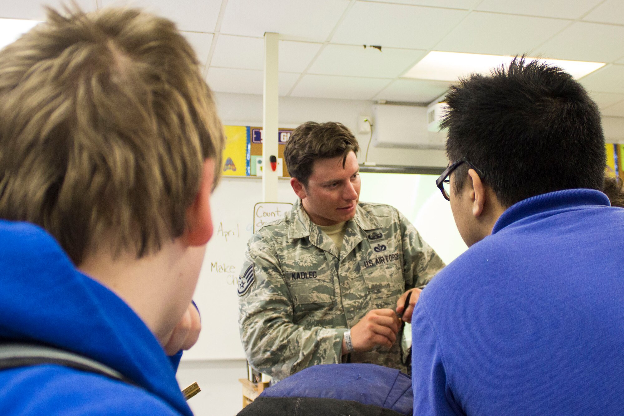 Staff Sgt. Micah Price, an explosive ordnance disposal technician at the 823rd RED HORSE Squadron at Tyndall AFB’s Silver Flag Exercise Site, shows students how to use a pair of heads-up display glasses during a robotics presentation at Everitt Middle School, Panama City, April 9. Representatives from the Air Force Civil Engineer Center at Tyndall and the  823rd RHS taught students about working in a science, technology, engineering and math field for National Robotics Week. (U.S. Air Force photo/Released)