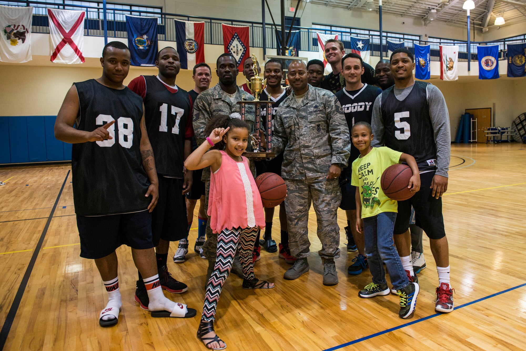 The 824th Base Defense Squadron pose for a photo after winning Moody Air Force Base’s intramural basketball championship game April 8, 2015, at the Freedom 1 Fitness Center.  The 824th BDS finished strong with a score of 58-56 after the 23d Logistics Readiness Squadron was unable to make the comeback. (U.S. Air Force photo by Airman 1st Class Dillian Bamman/Released)