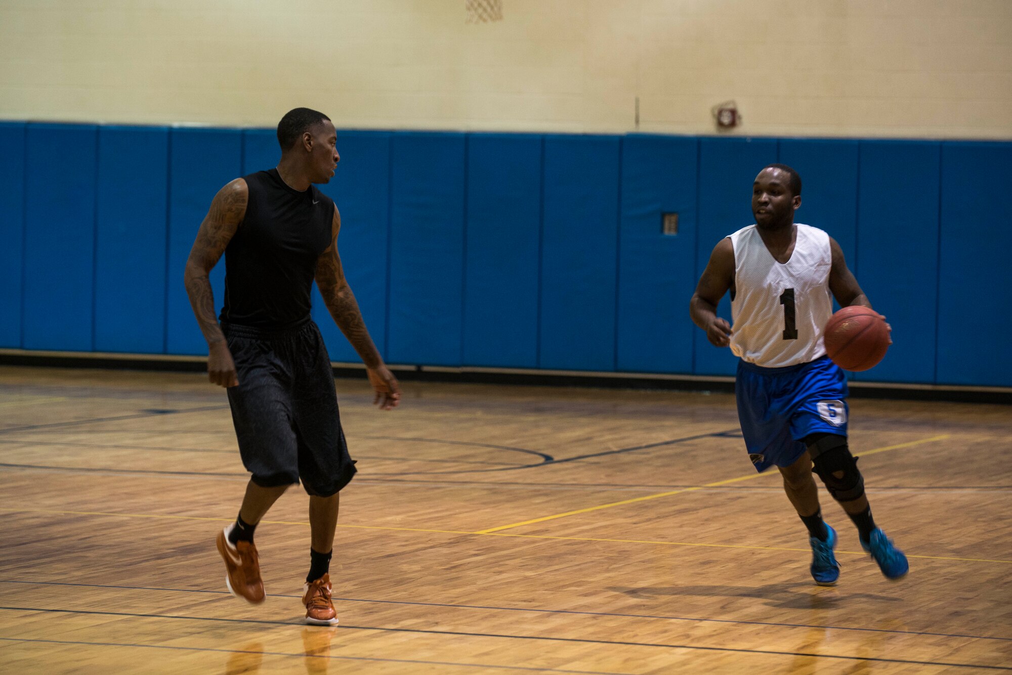 Basketball players from the 824th Base Defense Squadron and 23d Logistics Readiness Squadron face off during Moody Air Force Base’s intramural basketball championship game April 8, 2015, at the Freedom 1 Fitness Center. Starting the game, the 23d LRS held the advantage for not losing during the double-elimination tournament. (U.S. Air Force photo by Airman 1st Class Dillian Bamman/Released)