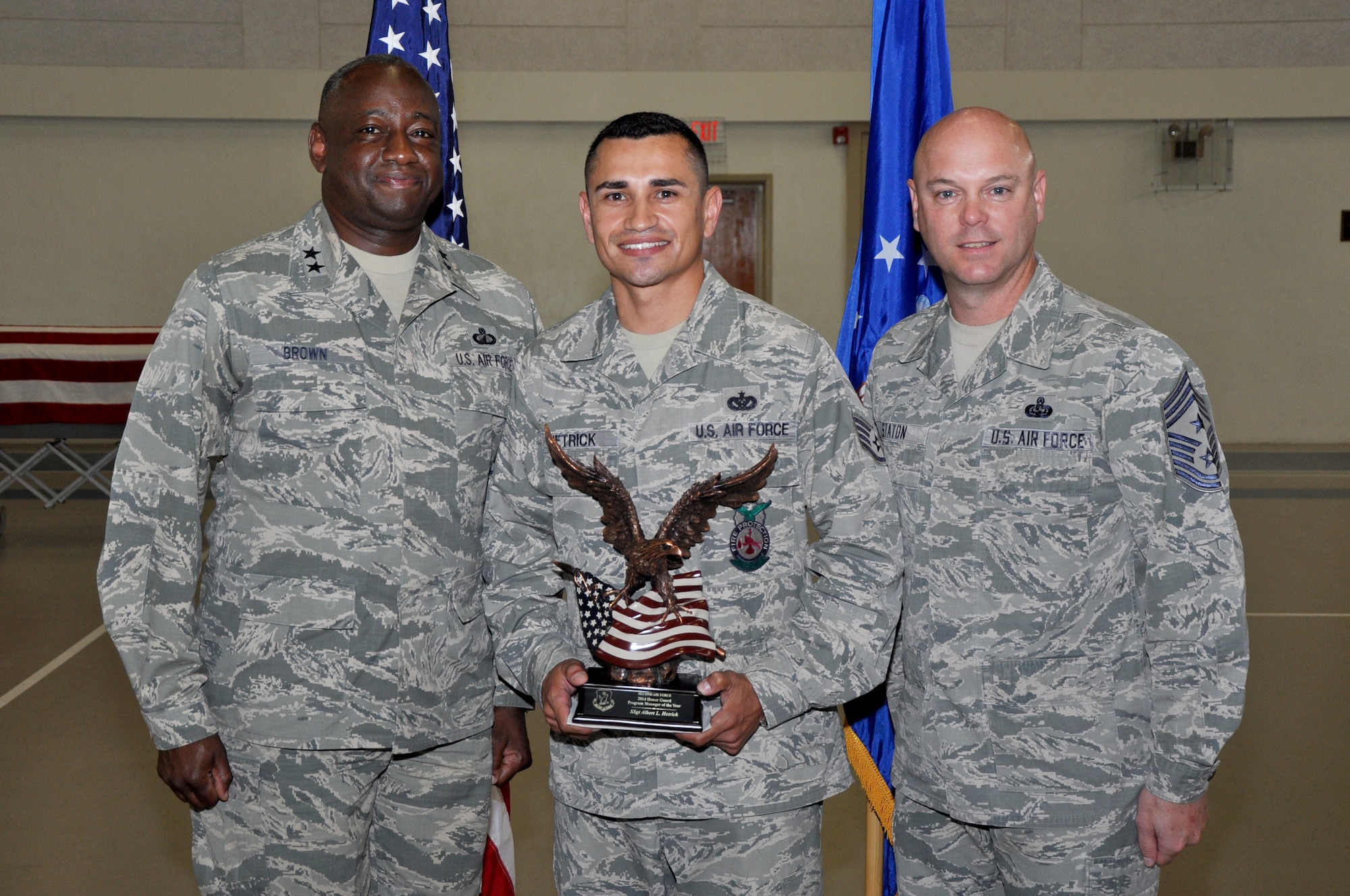 GOODFELLOW AIR FORCE BASE, Texas – Maj. Gen. Mark A. Brown, Second Air Force Commander, and Chief Master Sergeant David R. Staton, Second Air Force command chief master sergeant, present the 2014 Honor Guard Program Manager of the Year Award Second Air Force to Staff Sgt. Albert L. Hetrick, 312th Training Squadron Honor Guard NCO in charge at the Carswell Field House April 8. Hetrick is also the 2014 Air Education and Training Command Honor Guard Program Manager of the Year. (U.S. Air Force photo/ Senior Airman Joshua Edwards)