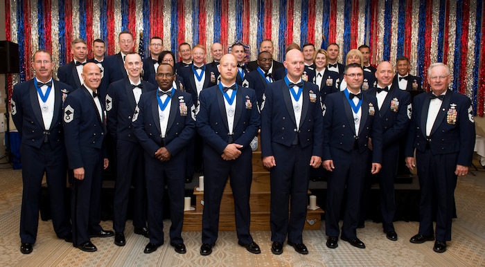 Joint Base Charleston Chiefs pose for a group photo with newly promoted chiefs and chief selects April 11, 2015, at the Charleston Club on Joint Base Charleston, S.C. The intent of the ceremony is to honor the chief master sergeants and their families for achieving this impressive milestone in their careers. (U.S. Air Force photo/Airman 1st Class Clayton Cupit)