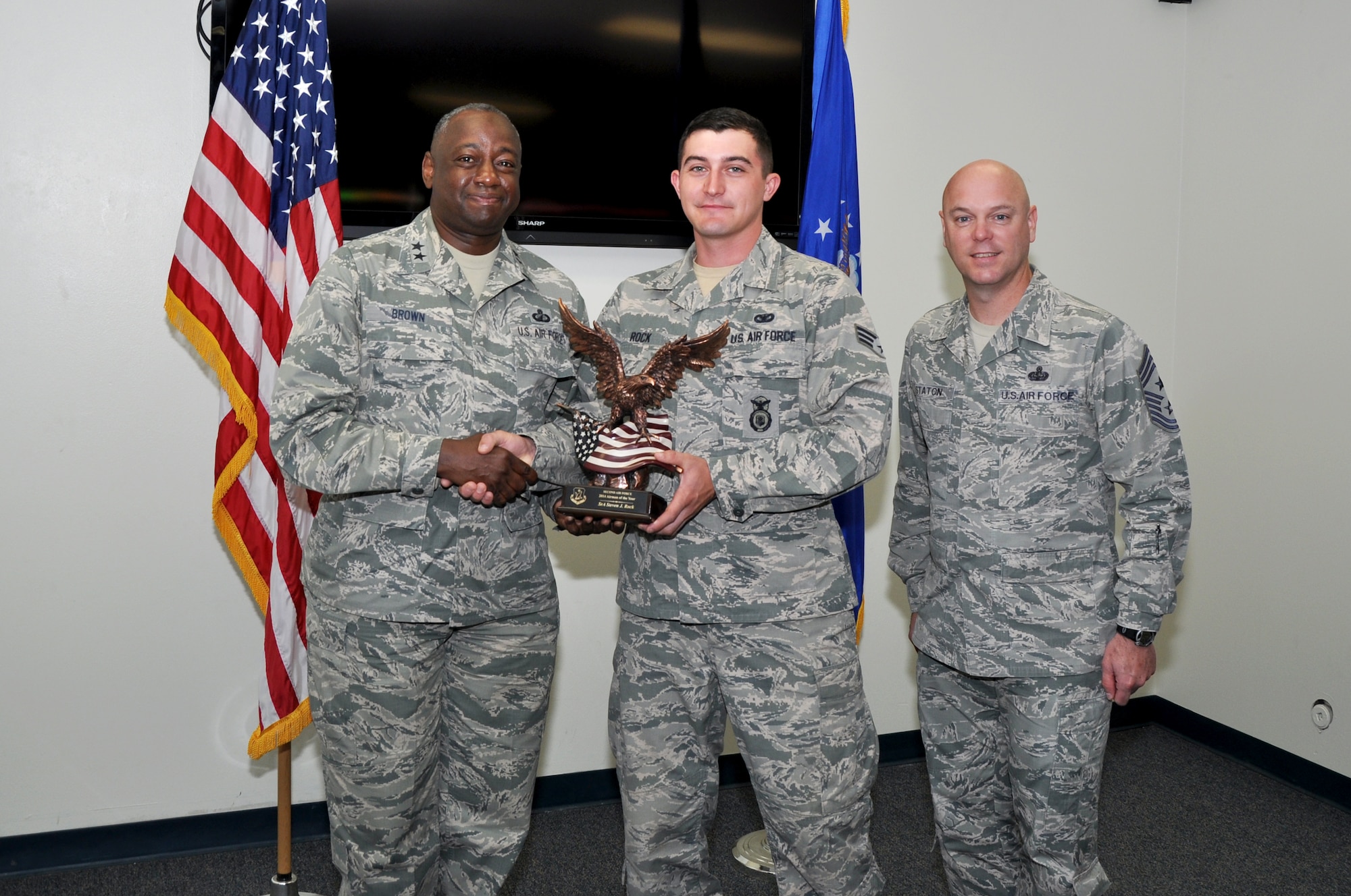 GOODFELLOW AIR FORCE BASE, Texas – Maj. Gen. Mark A. Brown, Second Air Force Commander, and Chief Master Sergeant David R. Staton, Second Air Force command chief master sergeant, present the 2014 Airman of the Year Award for Second Air Force to Senior Airman Steven J. Rock, 17th Security Forces Squadron Trainer, at the 17th SFS April 8. Rock helps prepare future security forces Airmen and Marine augmentees to perform security forces duties. (U.S. Air Force photo/ Senior Airman Joshua Edwards)