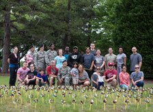 Airmen, civilians and family members from the Holocaust Remembrance committee pose for a group photo behind 1,000 pinwheels April 12, 2015 at Joint Base Charleston, S.C. Holocaust Remembrance Day is Thursday April 16, 2015 and the pinwheels represent the six million victims of the Holocaust. The pinwheels will be displayed as a memorial for a week on the corner of Hill and O’Neil Blvd. (U.S. Air Force photo/Senior Airman Jared Trimarchi)