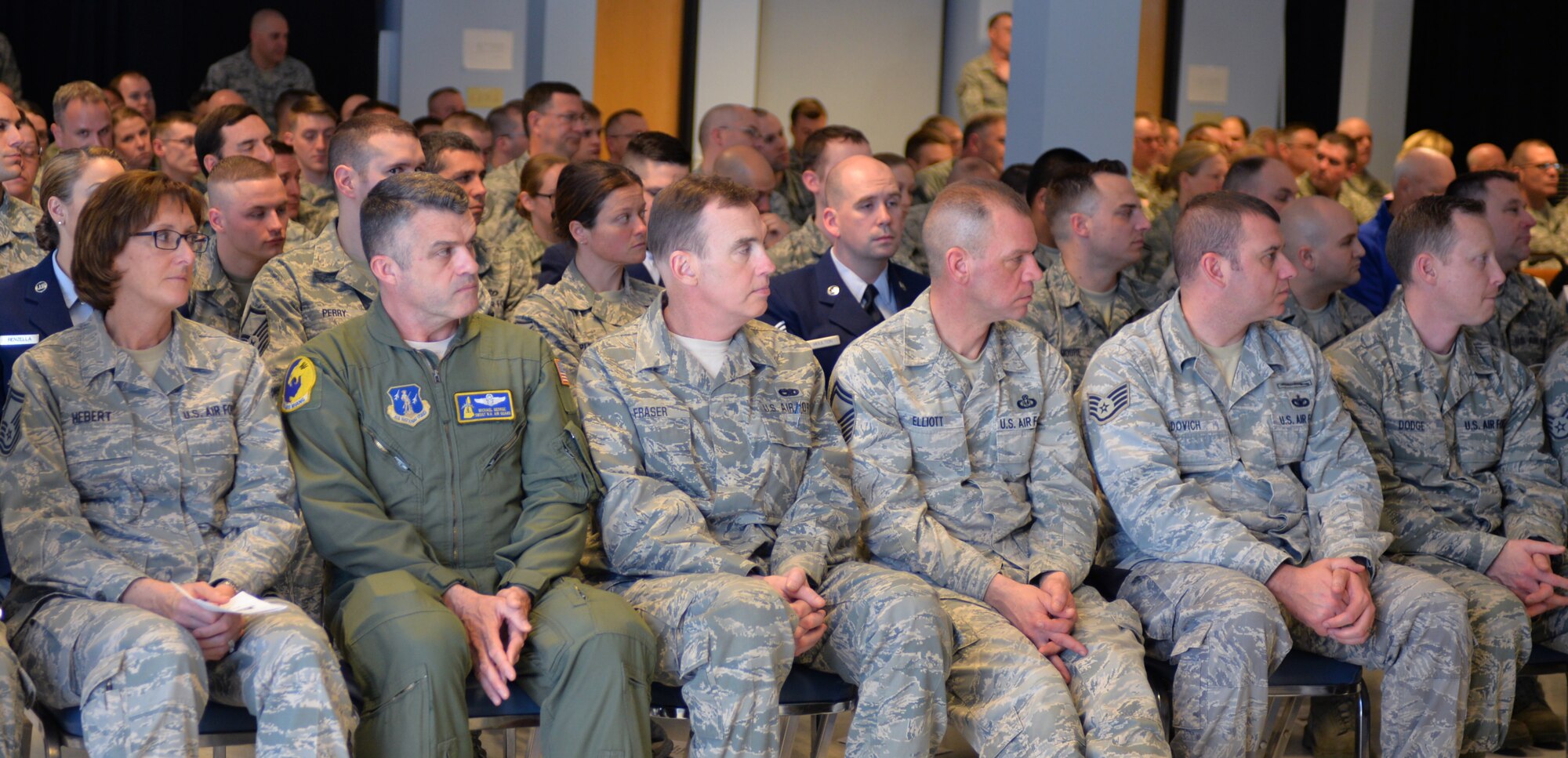 Airmen assigned to the 157th Air Refueling Wing listen to a speaker during a graduation ceremony April 12, 2015 at Pease Air National Guard Base. The airmen were recognized during a combined Community College of the Air Force and Professional Military Education graduation ceremony. (N.H. Air National Guard photo by Airman Ashlyn J. Correia/RELEASED) 