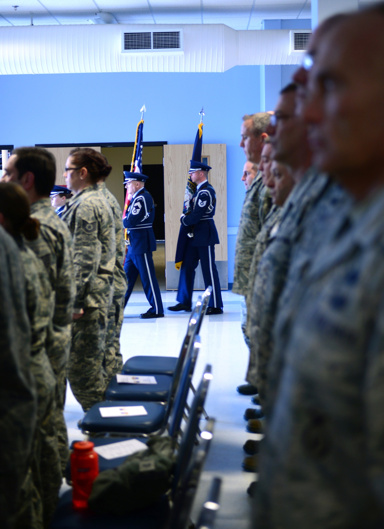The New Hampshire Air National Guard Honor Guard marches past airmen assigned to the 157th Air Refueling Wing during a ceremony April 12, 2015 at Pease Air National Guard Base. The airmen were recognized during a combined Community College of the Air Force and Professional Military Education graduation ceremony. (N.H. Air National Guard photo by Airman Ashlyn J. Correia/RELEASED) 
