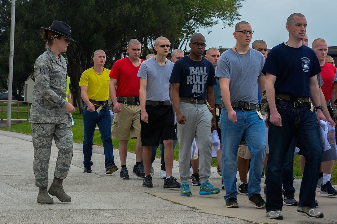 Tech. Sgt. Colleen Barringer, a United States Air Force military training instructor from the 331st Training Squadron, marches a flight of newly arrived trainees after receiving their first Air Force haircuts at Joint Base Sano Antonio-Lackland, Texas, April 8, 2015. Known as the "Gateway to the Air Force," all enlisted Airmen complete basic military training at Lackland, where more than 30,000 new Airmen graduate every year. (U.S. Air Force photo/Tech. Sgt. Trevor Tiernan)