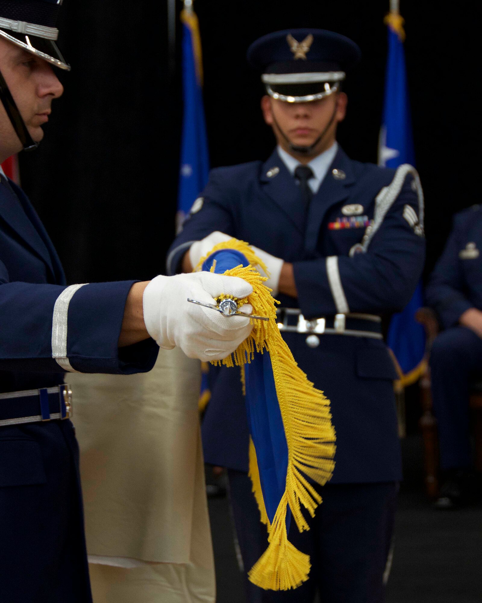 Senior Airman Luis Gordo and Staff Sgt. Andrew Merschel, members of the Homestead Air Reserve Base Honor Guard, unfurl Brig. Gen. Christian G. Funk’s personal flag during his promotion ceremony here. During the ceremony, Funk, the 482nd Fighter Wing commander was officially promoted to the rank of brigadier general at Homestead Air Reserve Base, Fla., April 11. (U.S. Air Force photo by Staff Sgt. Jaimi L. Upthegrove)