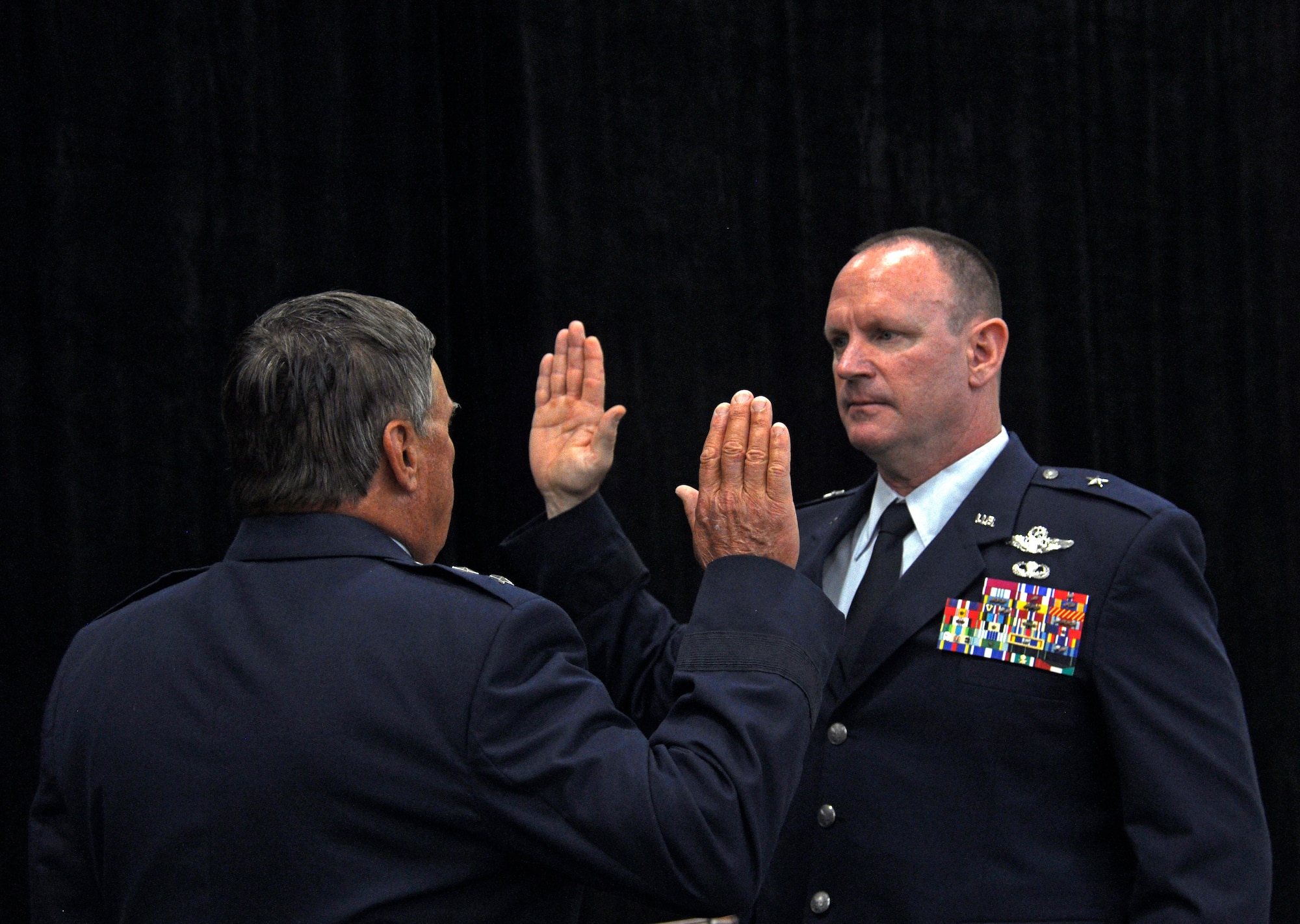Maj. Gen. (Ret.) Thomas Dyches, who served as the Assistant to the Chairman of the Joint Chiefs of Staff for Reserve Matters, administers the Oath of Appointment to Brig. Gen. Christian G. Funk during his promotion ceremony at Homestead Air Reserve Base, Fla., April 11. During the ceremony Funk, the 482nd Fighter Wing commander, was officially promoted to the rank of brigadier general. (U.S. Air Force photo by Senior Airman Nicholas Caceres)