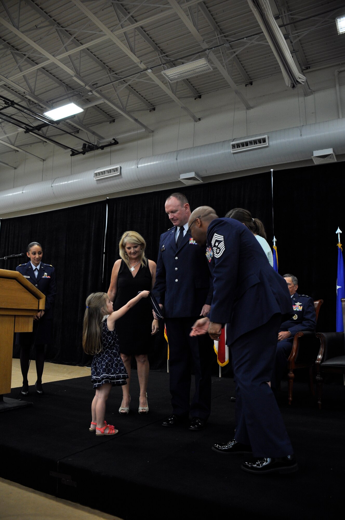 Charlotte, Brig. Gen. Christian G. Funk’s granddaughter, hands him his hat with his new rank during the promotion ceremony at Homestead Air Reserve Base, Fla., April 11. During the ceremony Funk, the 482nd Fighter Wing commander, was officially promoted to the rank of brigadier general. (U.S. Air Force photo by Senior Airman Nicholas Caceres)